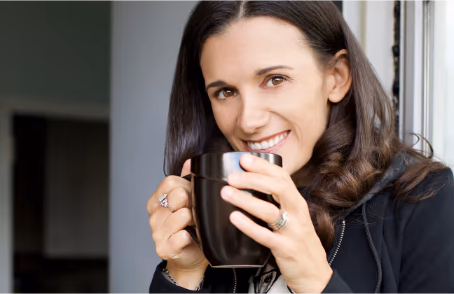 Jennifer James with a cup of coffee Coaching