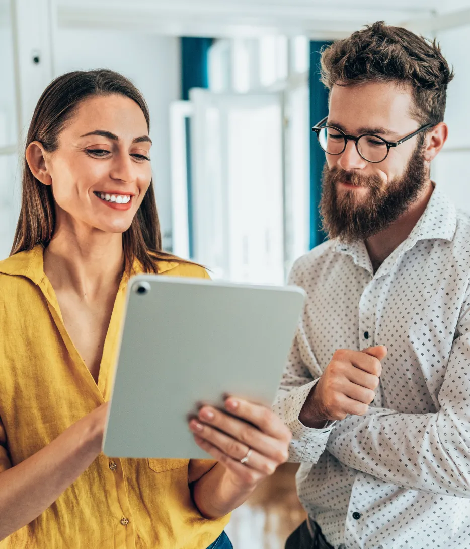 Two business owners reviewing their books on a tablet