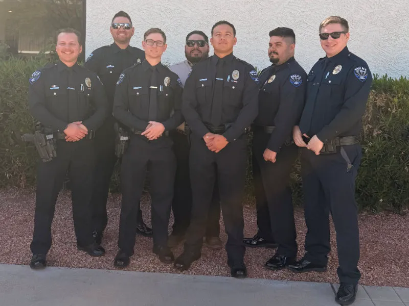 Three police officers with young girl outside