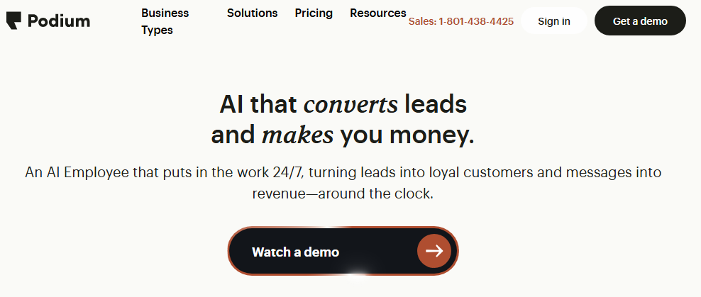 Podium homepage promoting an AI Employee that converts leads and messages into revenue, with a Watch a demo button.