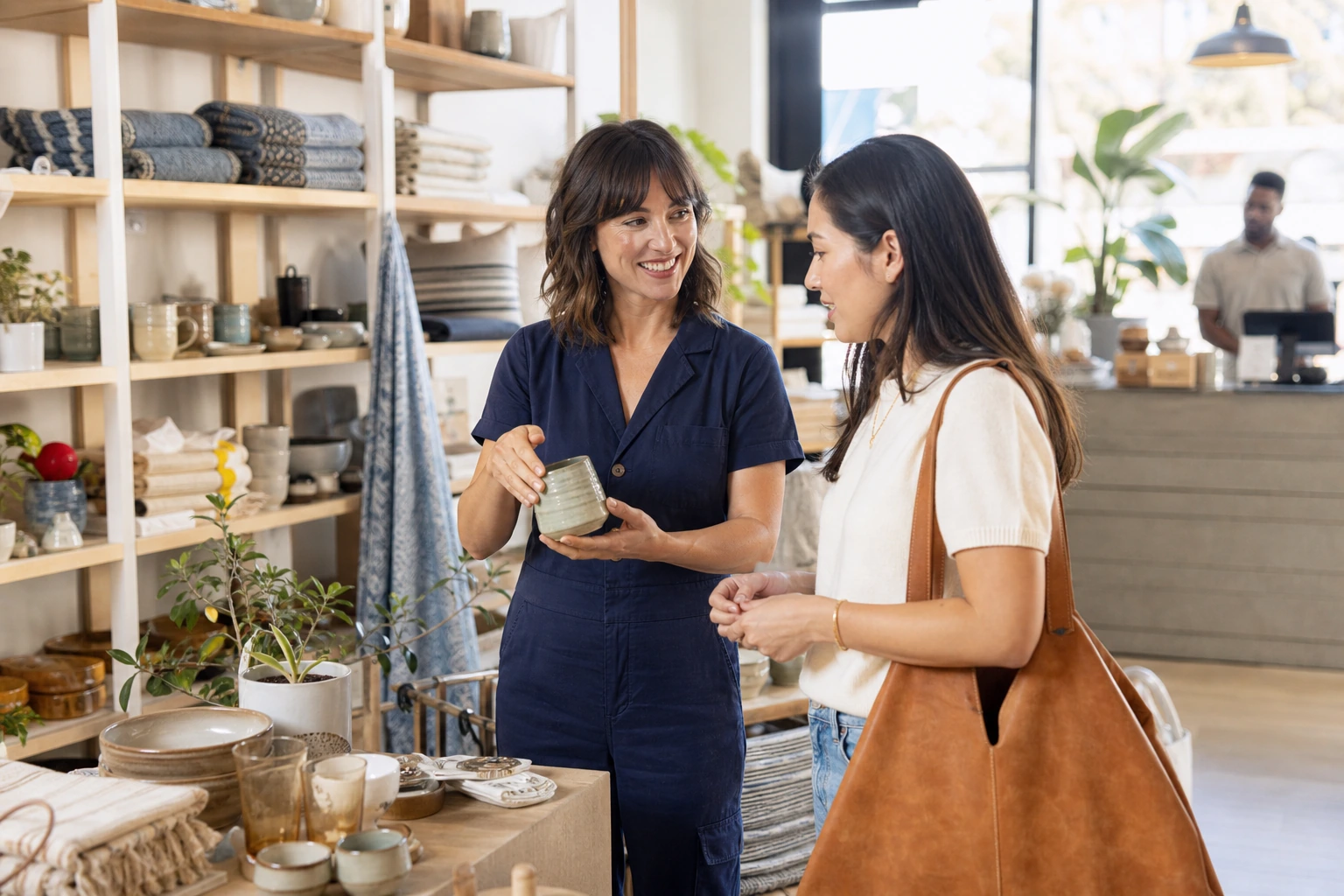 Retail associate helping a shopper choose a product in a home and lifestyle store