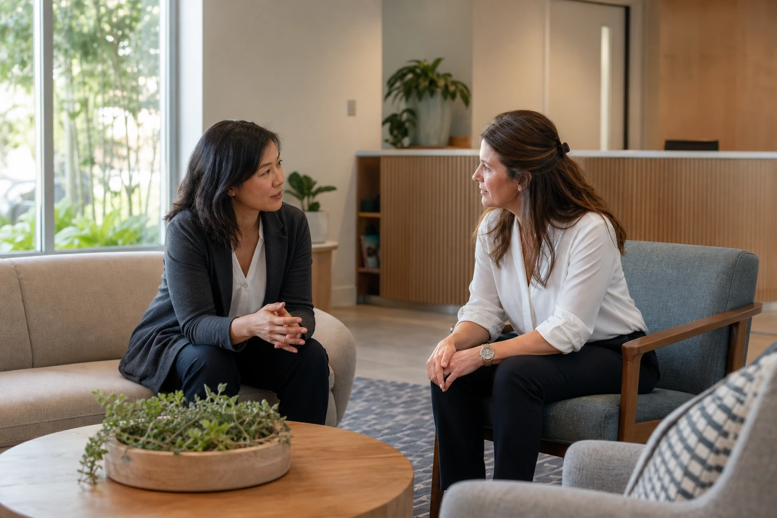 Behavioral health practice director and care coordinator speaking in a calm, welcoming reception area