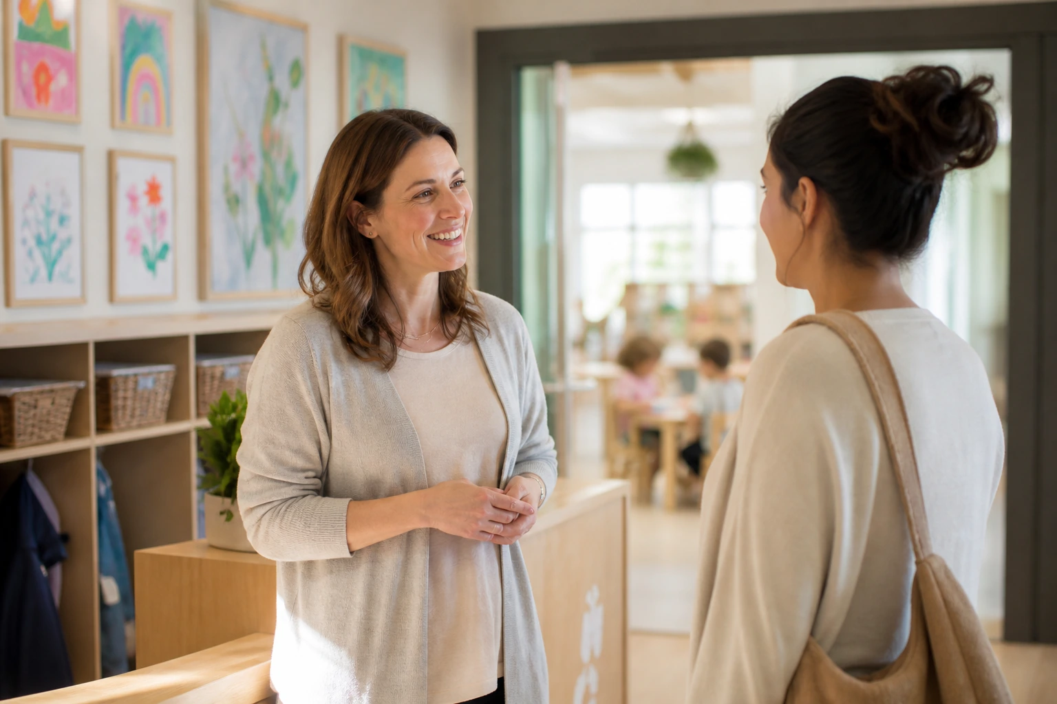 Child care center director speaking with a parent in a bright, welcoming center entrance