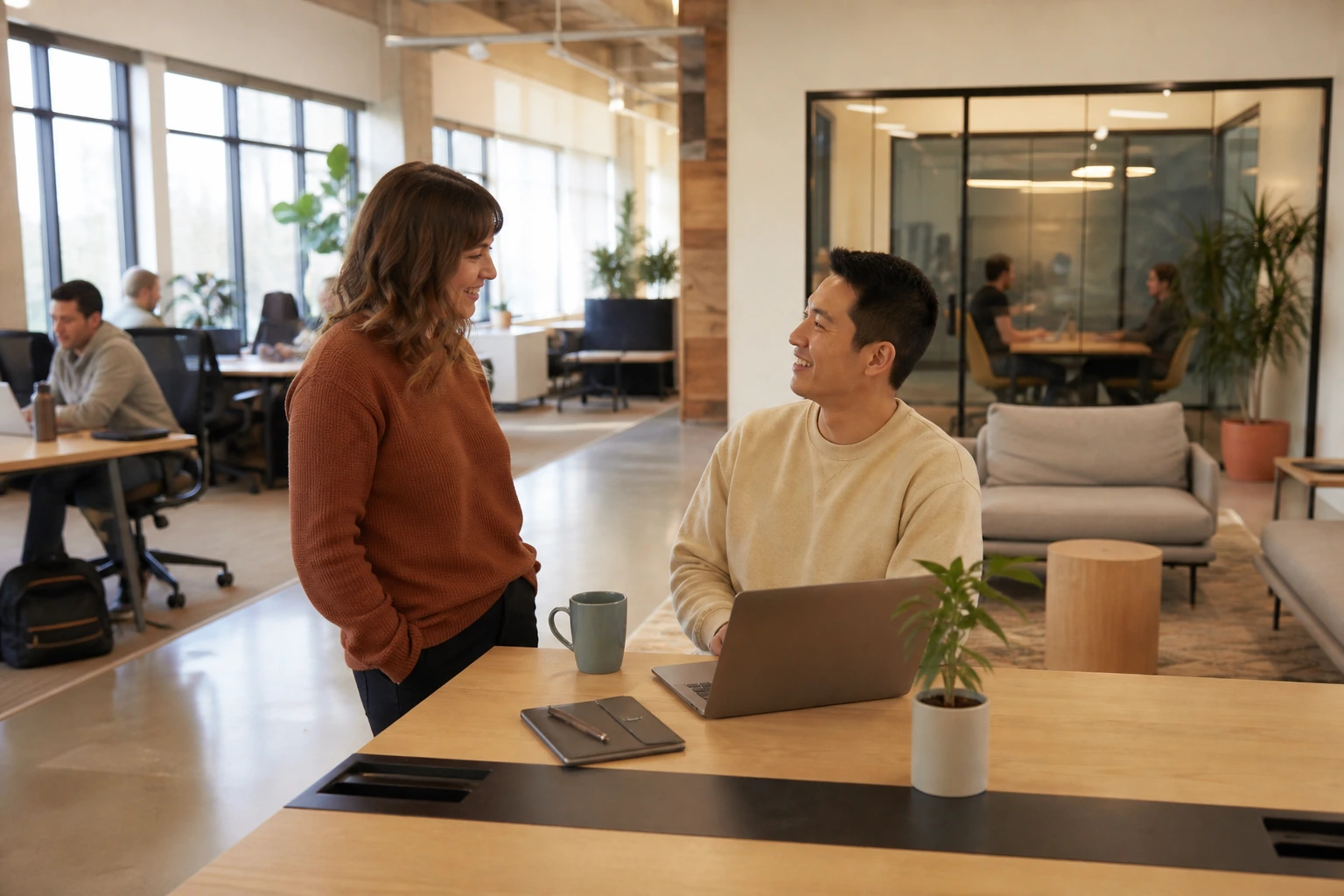 Coworking community manager checking in with a new member after completed onboarding in an active flexible workspace