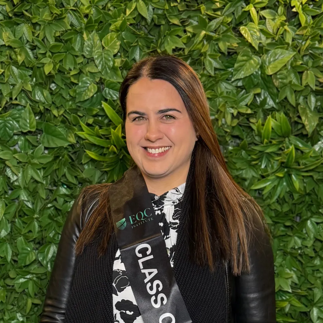 EQC Institute graduate wearing a graduation sash
