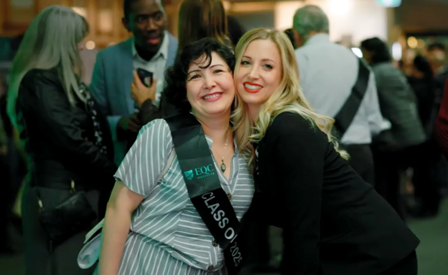 EQC Institute graduate celebrating with a guest at graduation