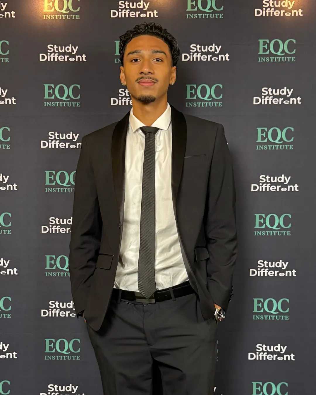 EQC Institute graduate in a suit at the EQC graduation event