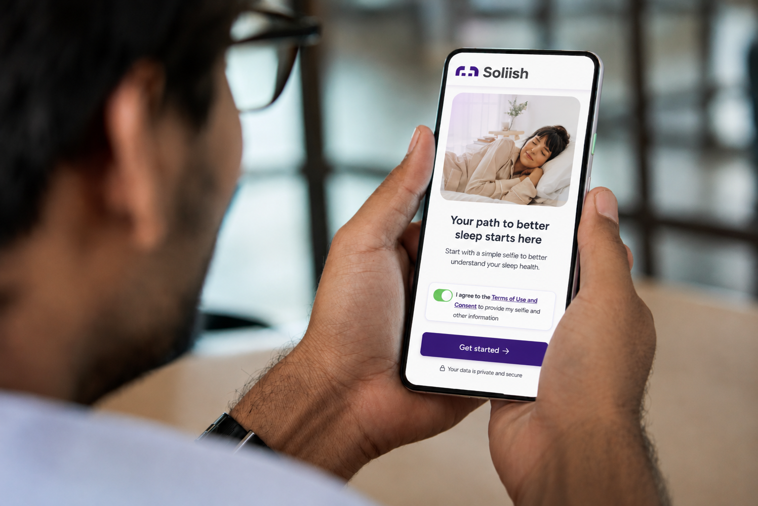 A user holding a phone using Soliish app in mobile phone