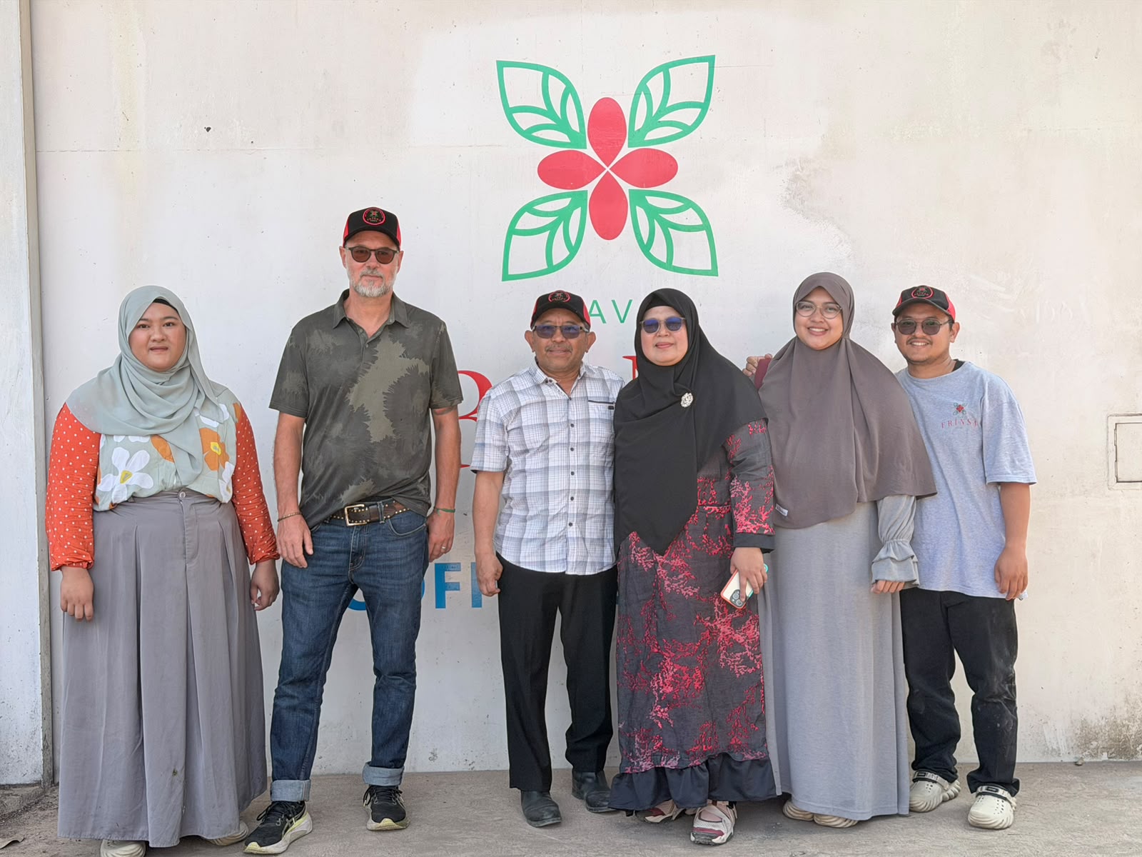 Wildan, Atieq, and Fikri, the family behind the business, standing together. Wildan and Atieq are in the center, while Wildan's son, Fikri, stands on the right and manages the day-to-day operations.