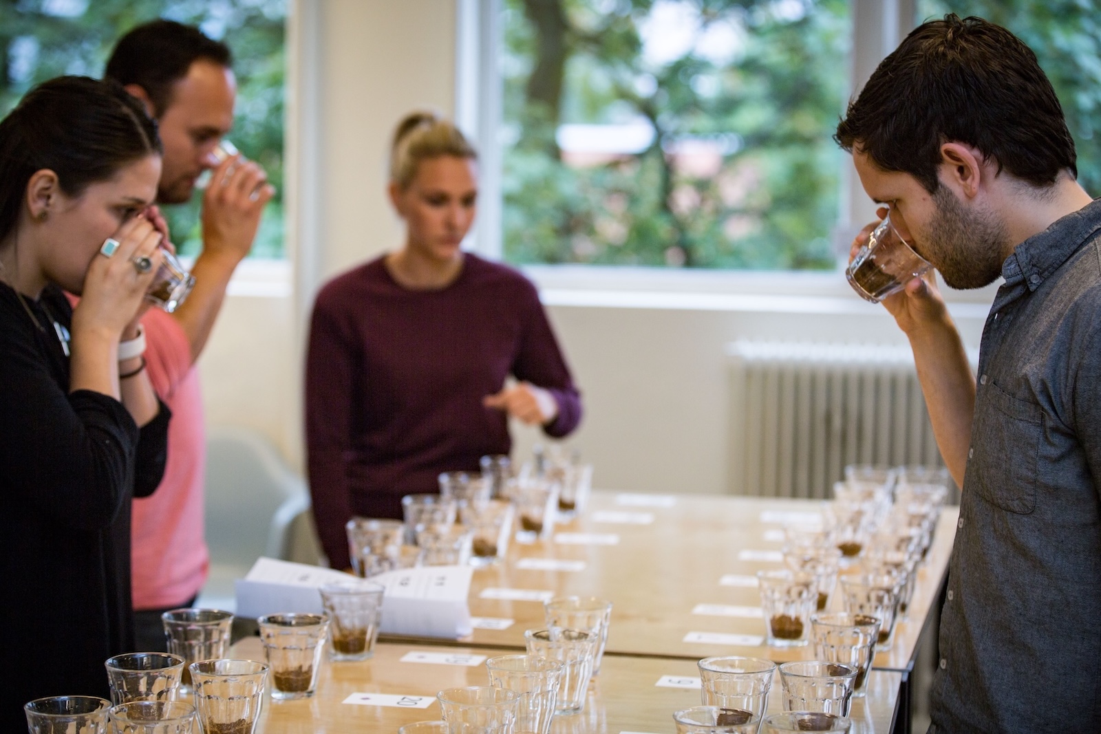 Alec Oyhenart, Nordic Approach's Director of Operations, evaluating dry aroma with the team during a cupping session.
