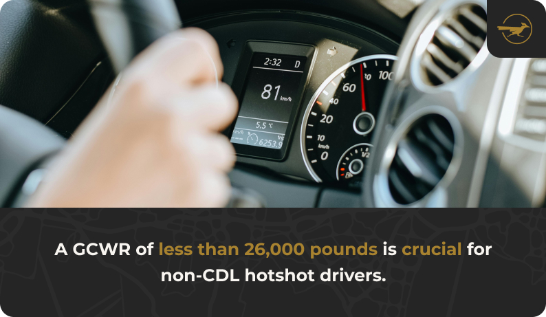 Image The closeup of a truck's dashboard with the driver's hands on the steering wheel. Text: A GCWR of less than 26,000 pounds is crucial for non-CDL hotshot drivers