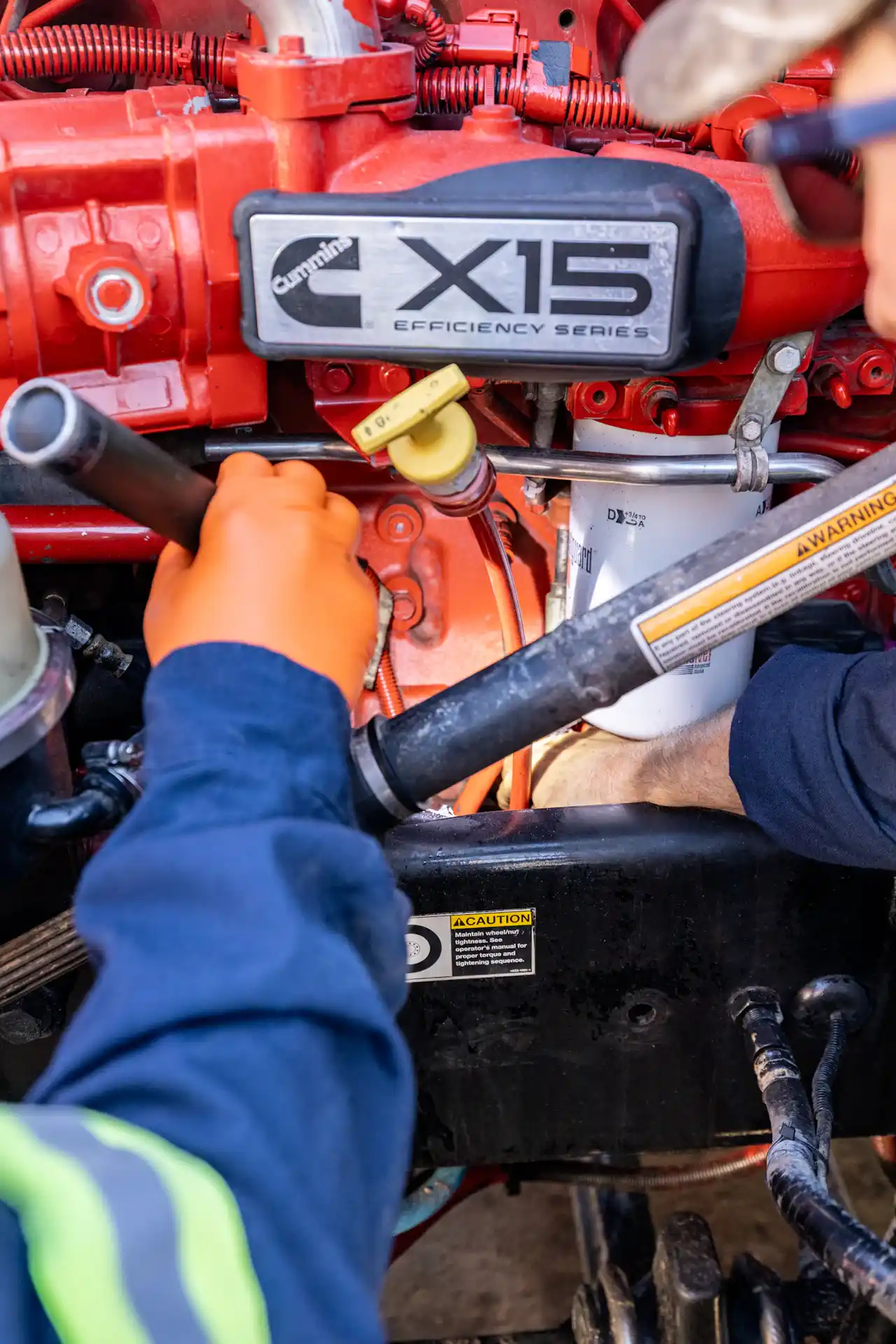 Technician servicing a Cummins X15 engine during heavy-duty repair. Cummins X15 Efficiency Series