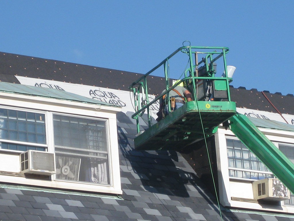 Replacing the original slate roof in the summer of 2010, part of the renovation that added the west tower and the building's first elevator. University YMCA.