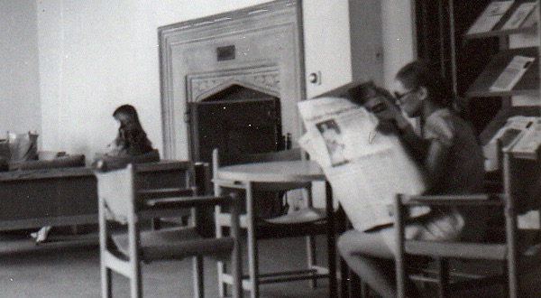 A student reads the newspaper in the Y's lounge, May 1970