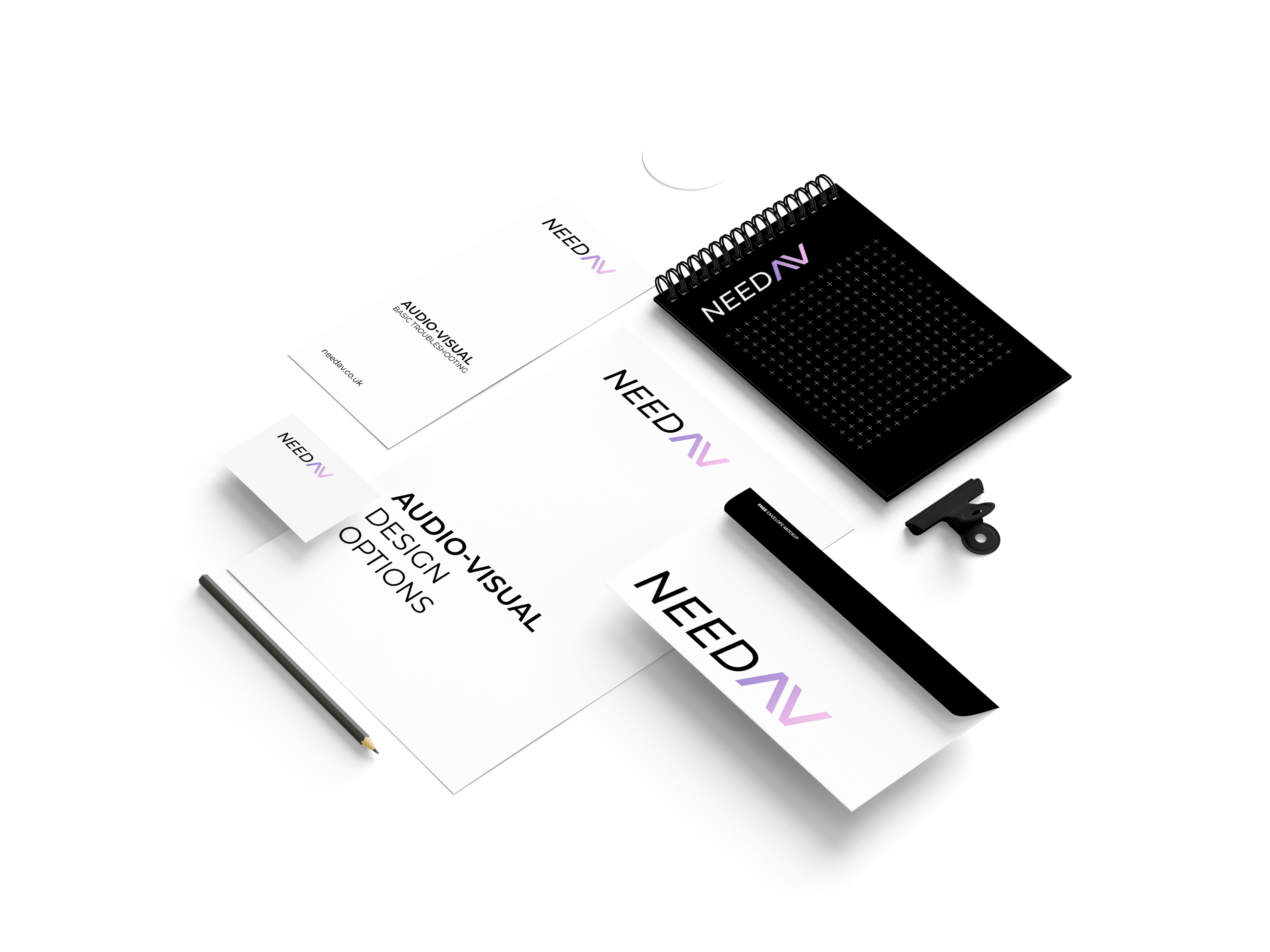 A set of branded stationery for Need AV including a spiral notebook with a black cover featuring a grid pattern and the logo, a white brochure titled AUDIO-VISUAL DESIGN OPTIONS, a business card, an envelope, a pencil, and a small black item, all displaying the Need AV logo.