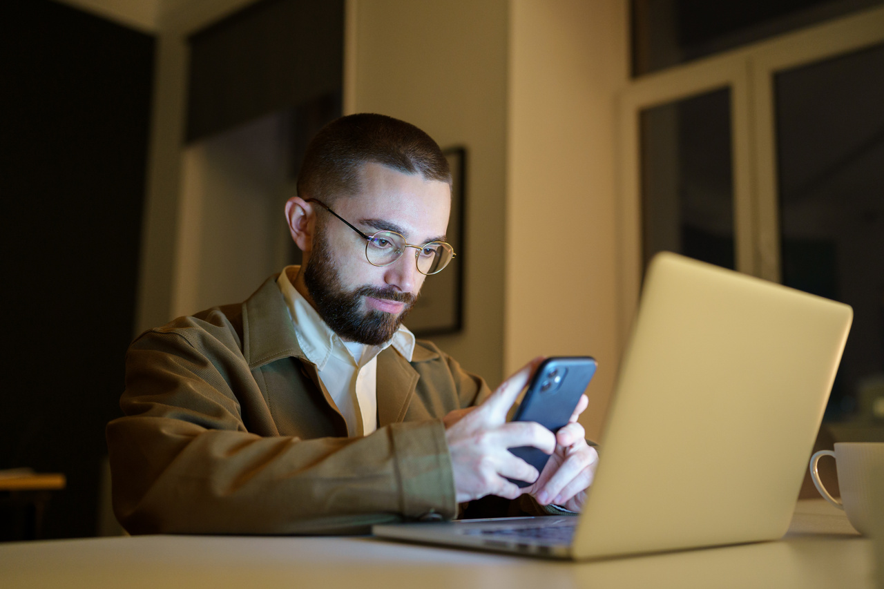 QA engineer testing chatbot application on multiple devices including tablet and smartphone