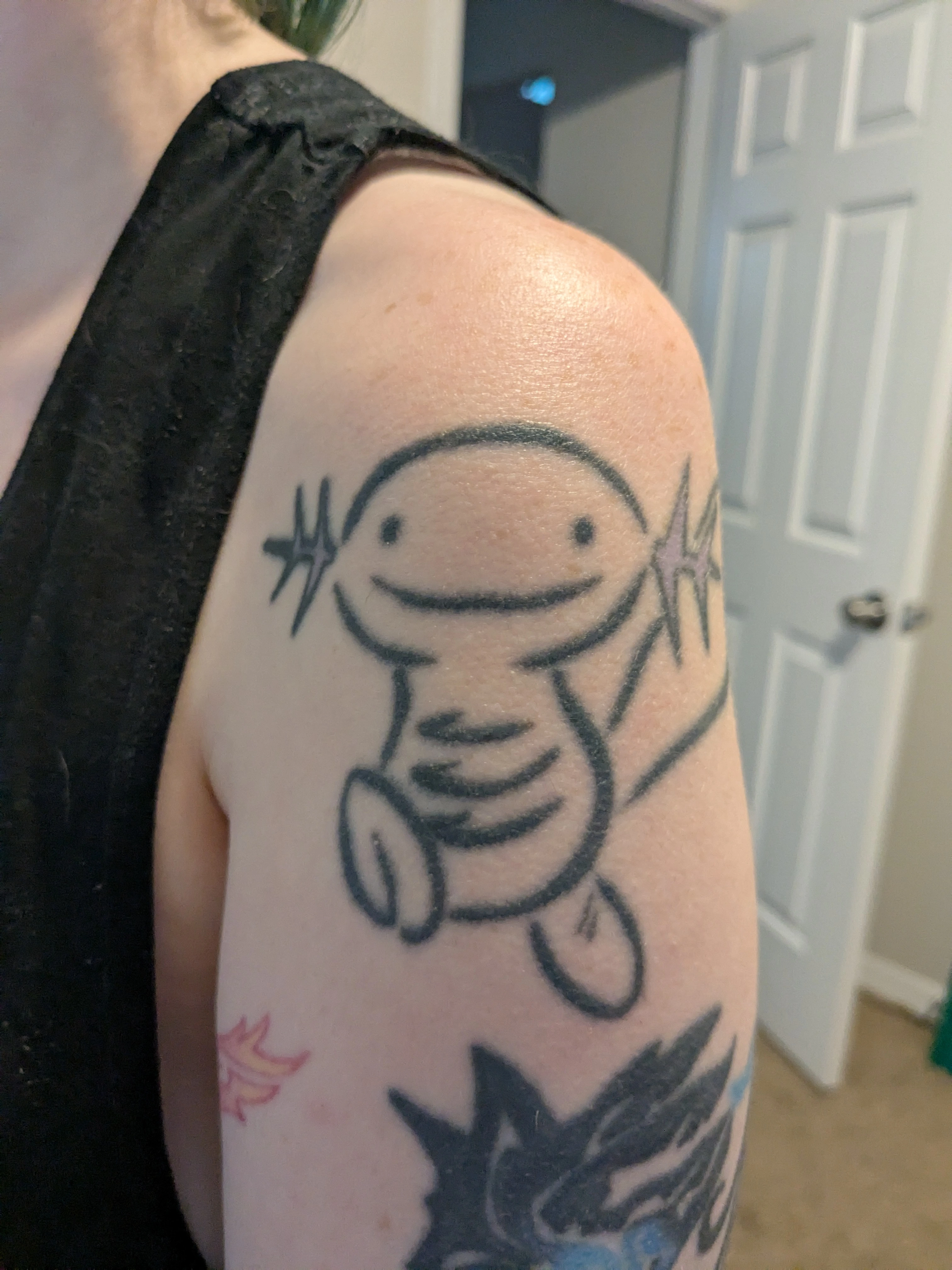 A tattoo of the Pokemon Wooper on a person's arm