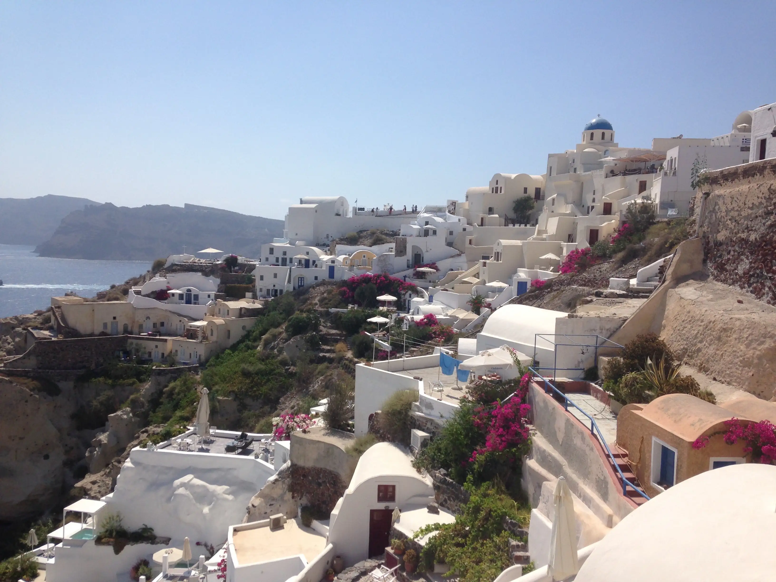 Several buildings built on a sloped hill of Santorini, Greece