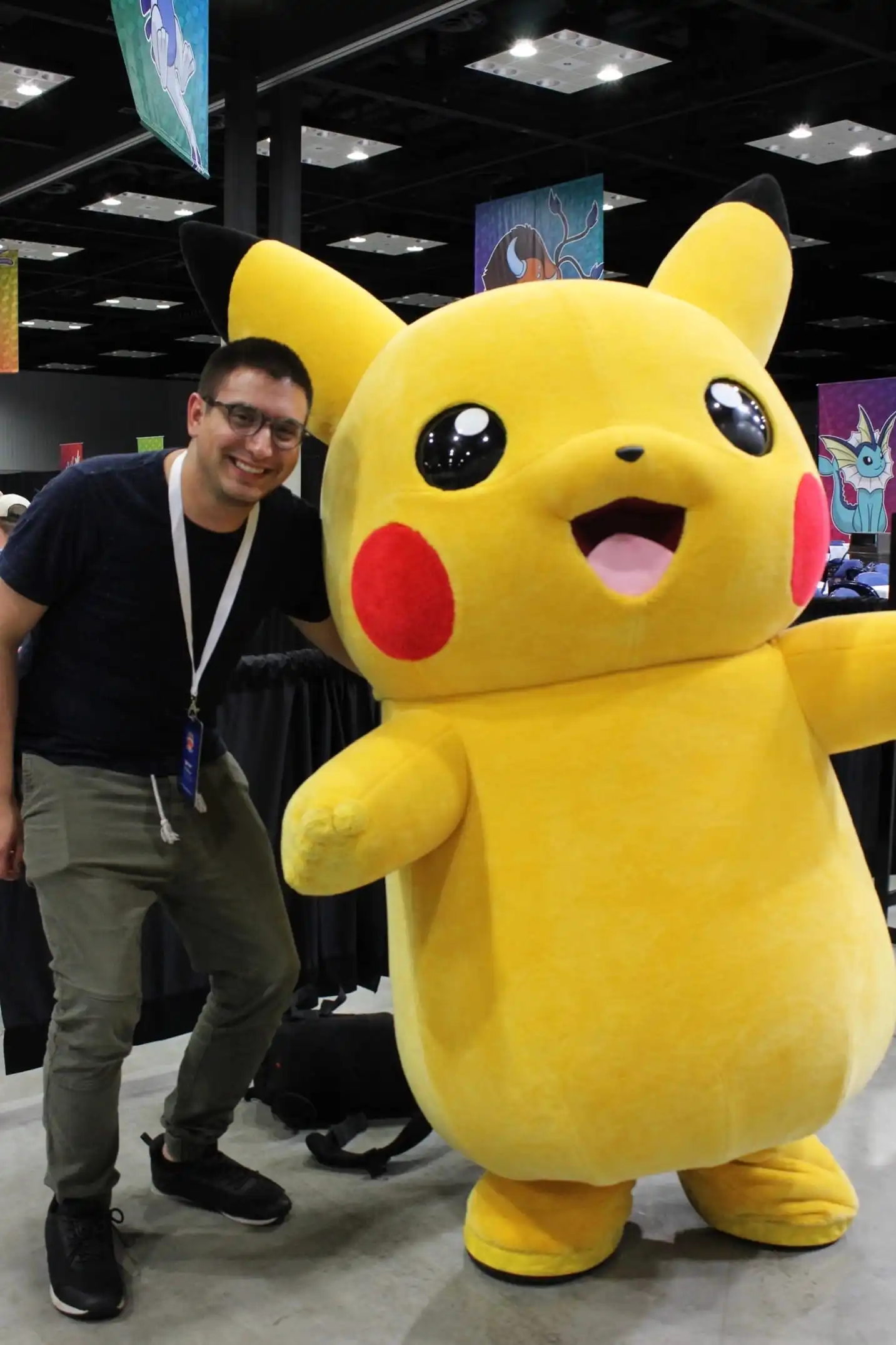 Steve smiling with a mascot sized Pikachu