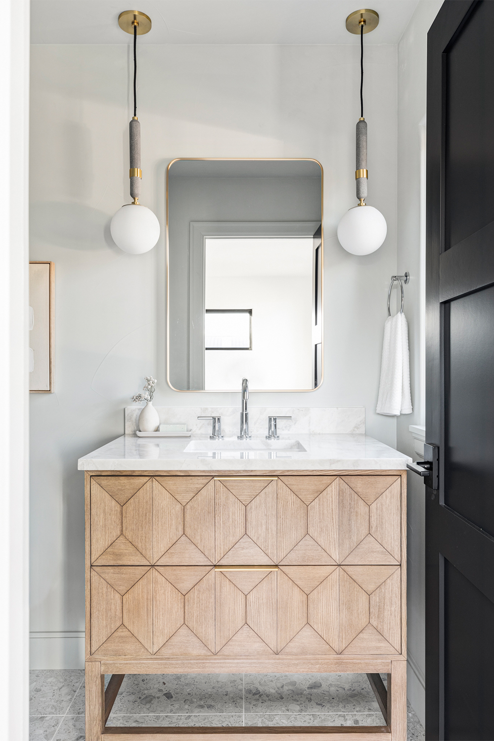 Modern bathroom vanity with textured wood cabinetry and sleek stone countertop in Cherry Creek Luxury Row Homes.