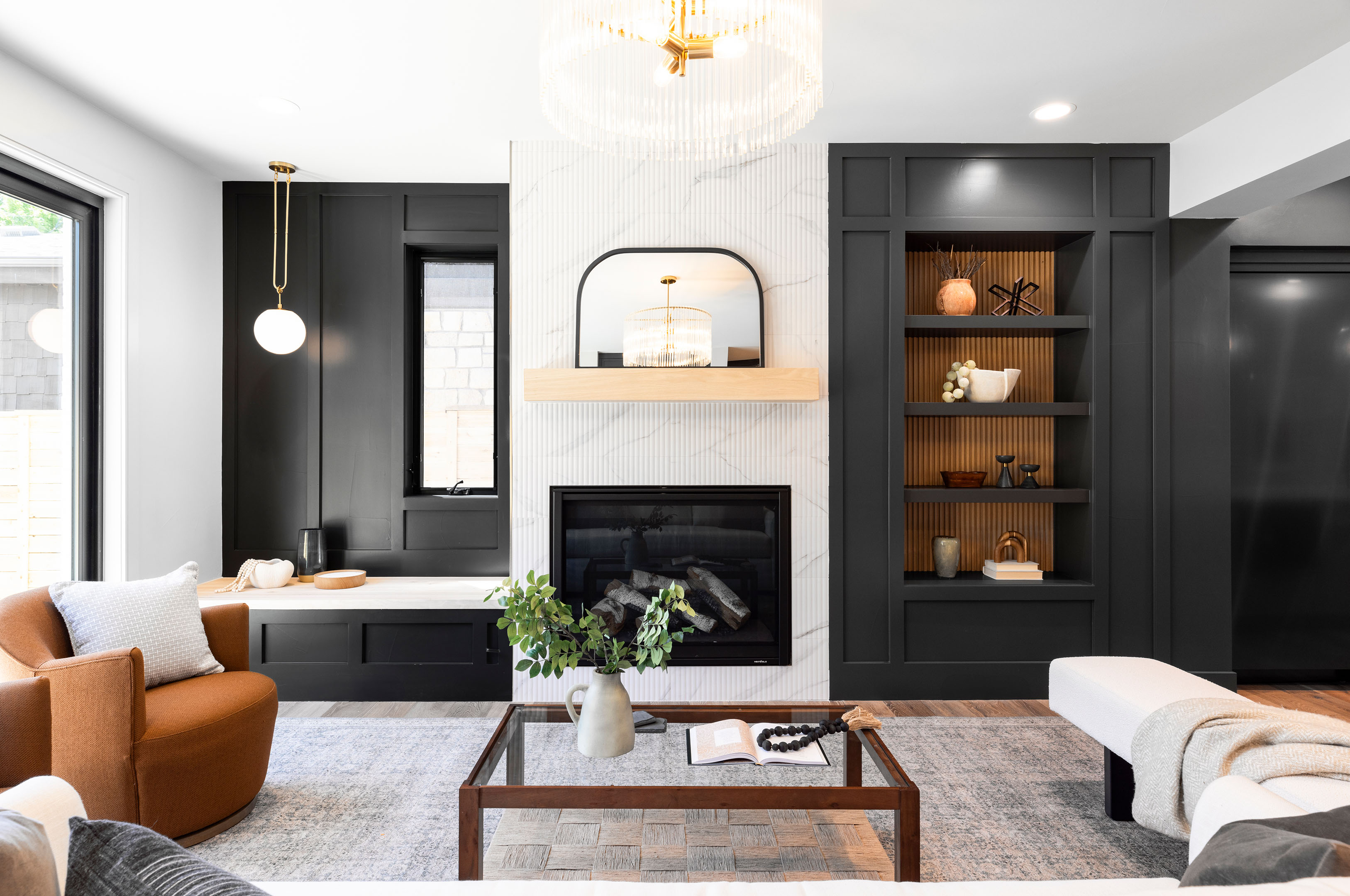 Spacious living area with sleek modern fireplace and open shelving detail.