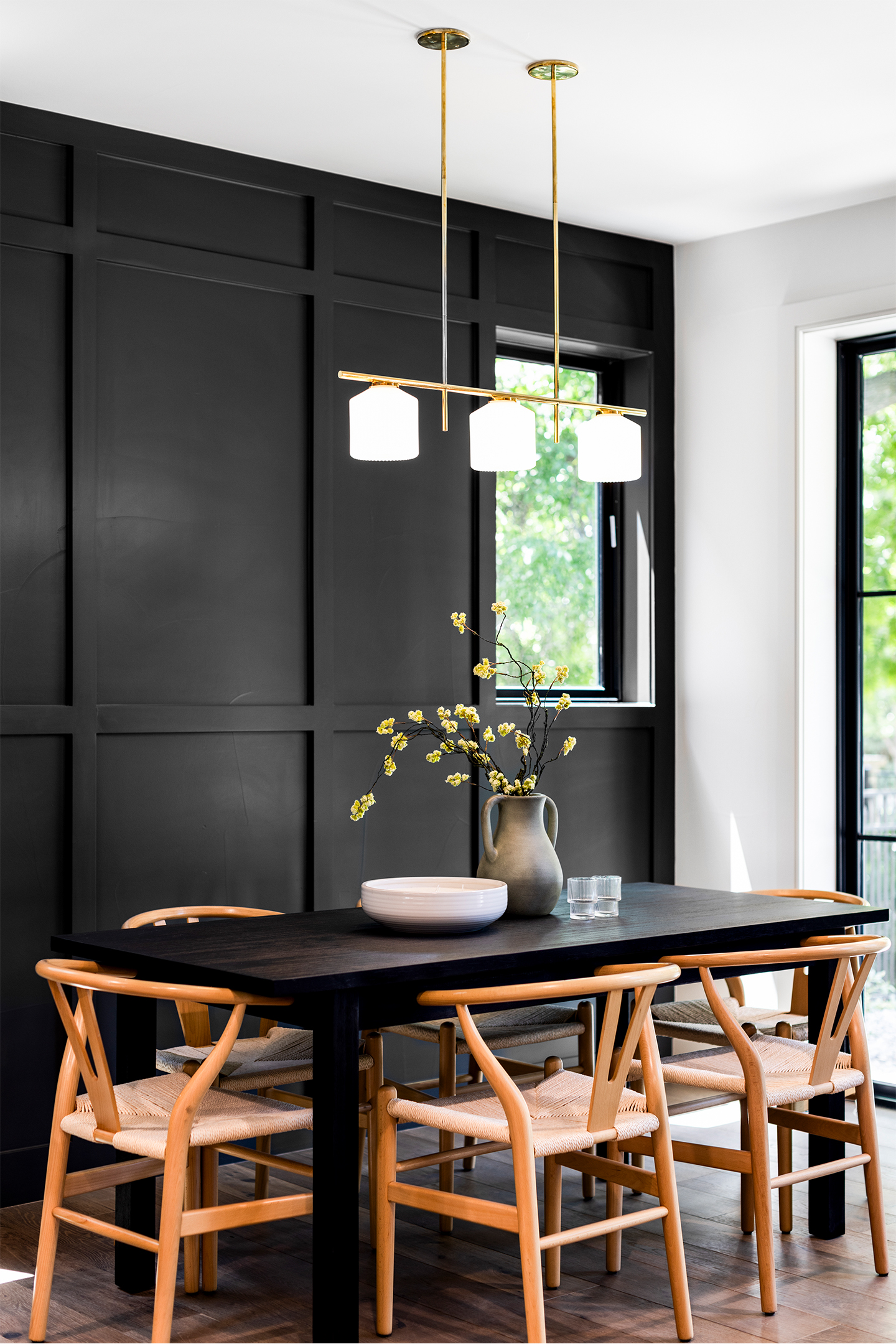 Modern dining area with black cabinetry and contemporary pendant lighting in Wash Park Luxury Paired Homes.