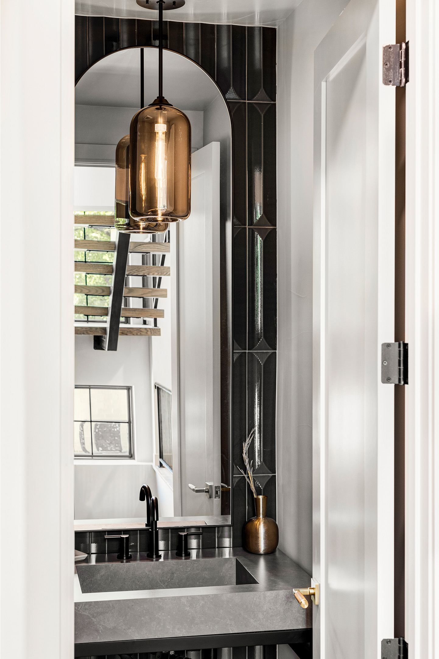 Vertical stairwell view showcasing modern lighting and architectural lines.