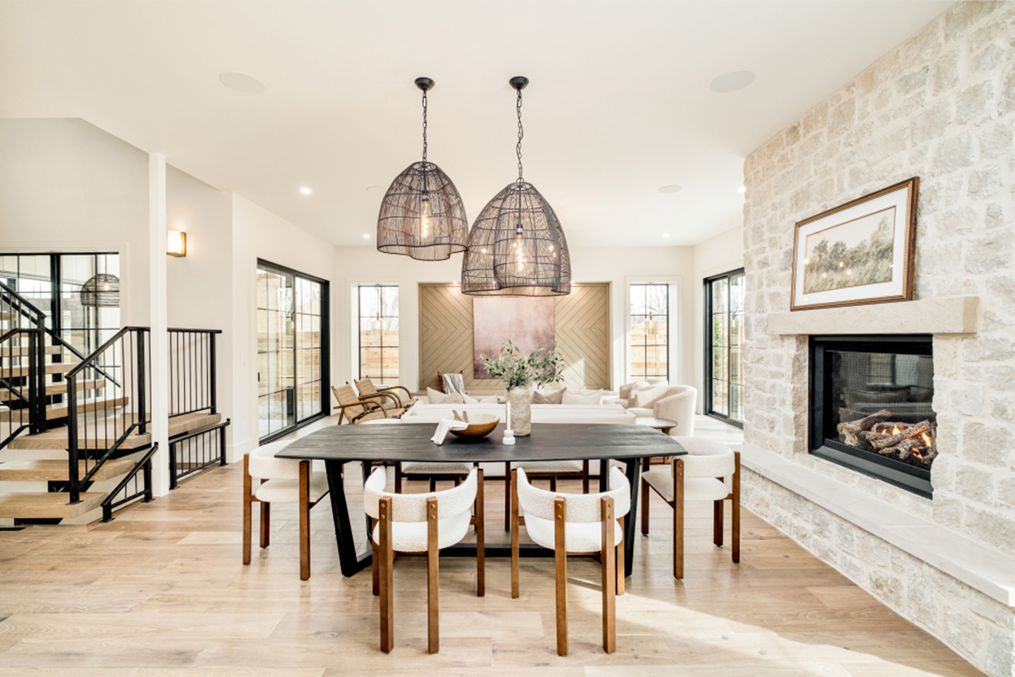 Open dining area with statement pendant lighting and modern fireplace in Observatory Park Modern Classic.