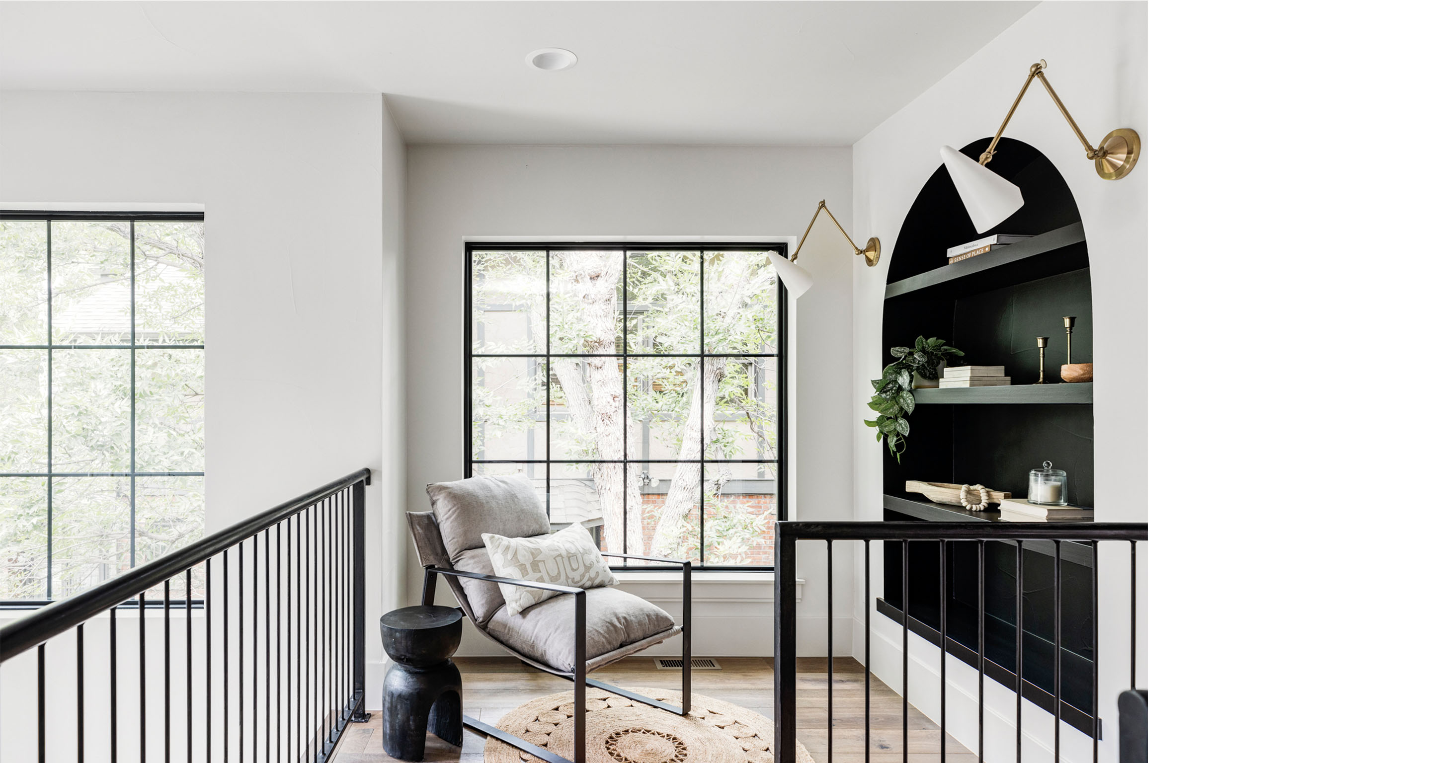 Interior loft view with modern railing overlooking open living space in Wash Park Modern Luxe home.