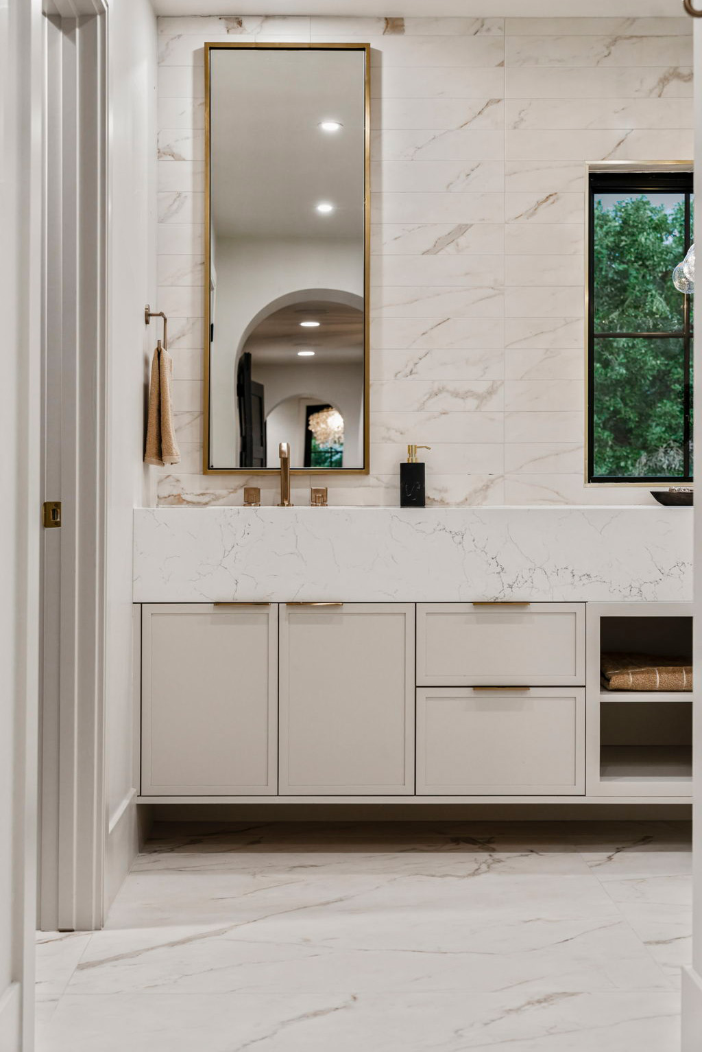Minimal modern bathroom vanity with marble finishes and sleek fixtures.