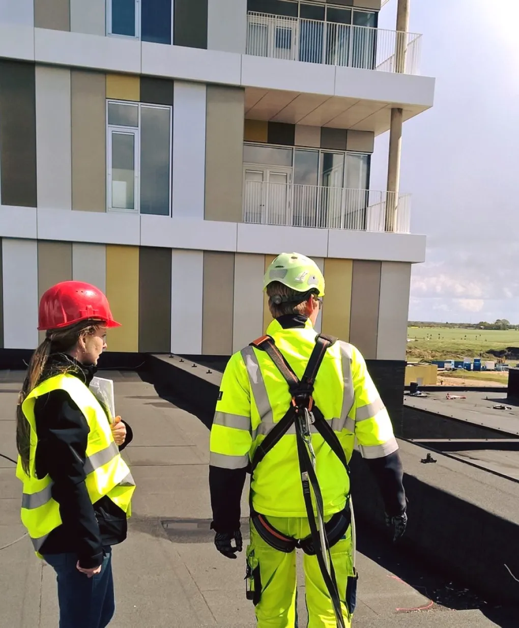 a man and a woman in safety vests and hard hats