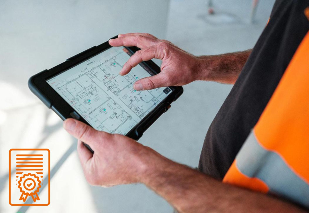 ICS worker looking at drawings on an iPad.