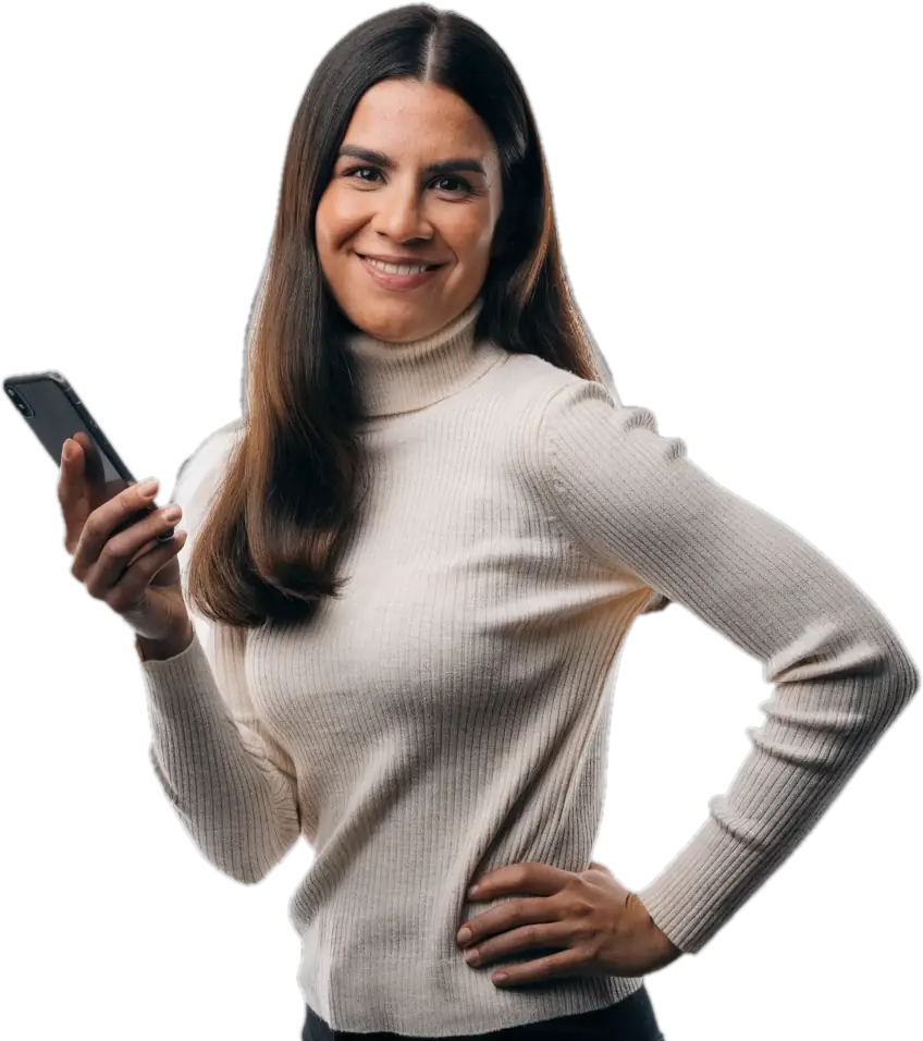 Smiling mother in a cream turtleneck holding her phone