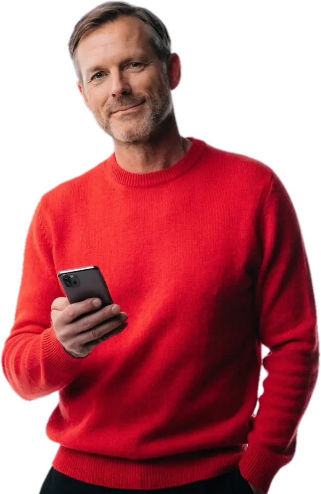 Father in a red sweater smiling at his phone