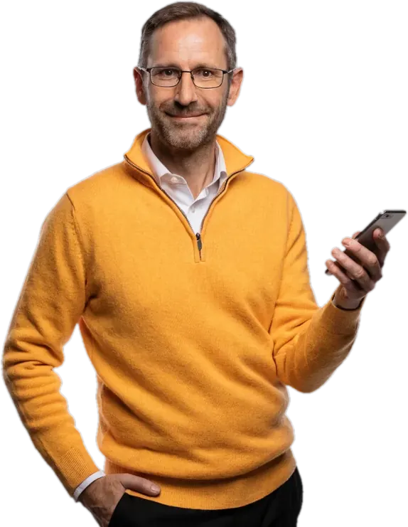 Smiling father in glasses and a marigold sweater checking his phone