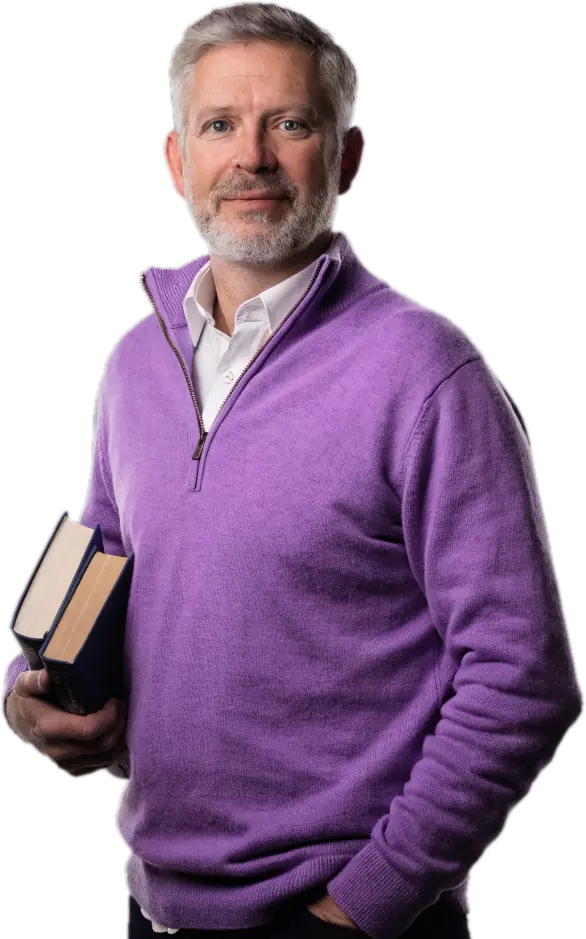 Smiling certified teacher in a lilac sweater holding books, ready to teach with Connect Education