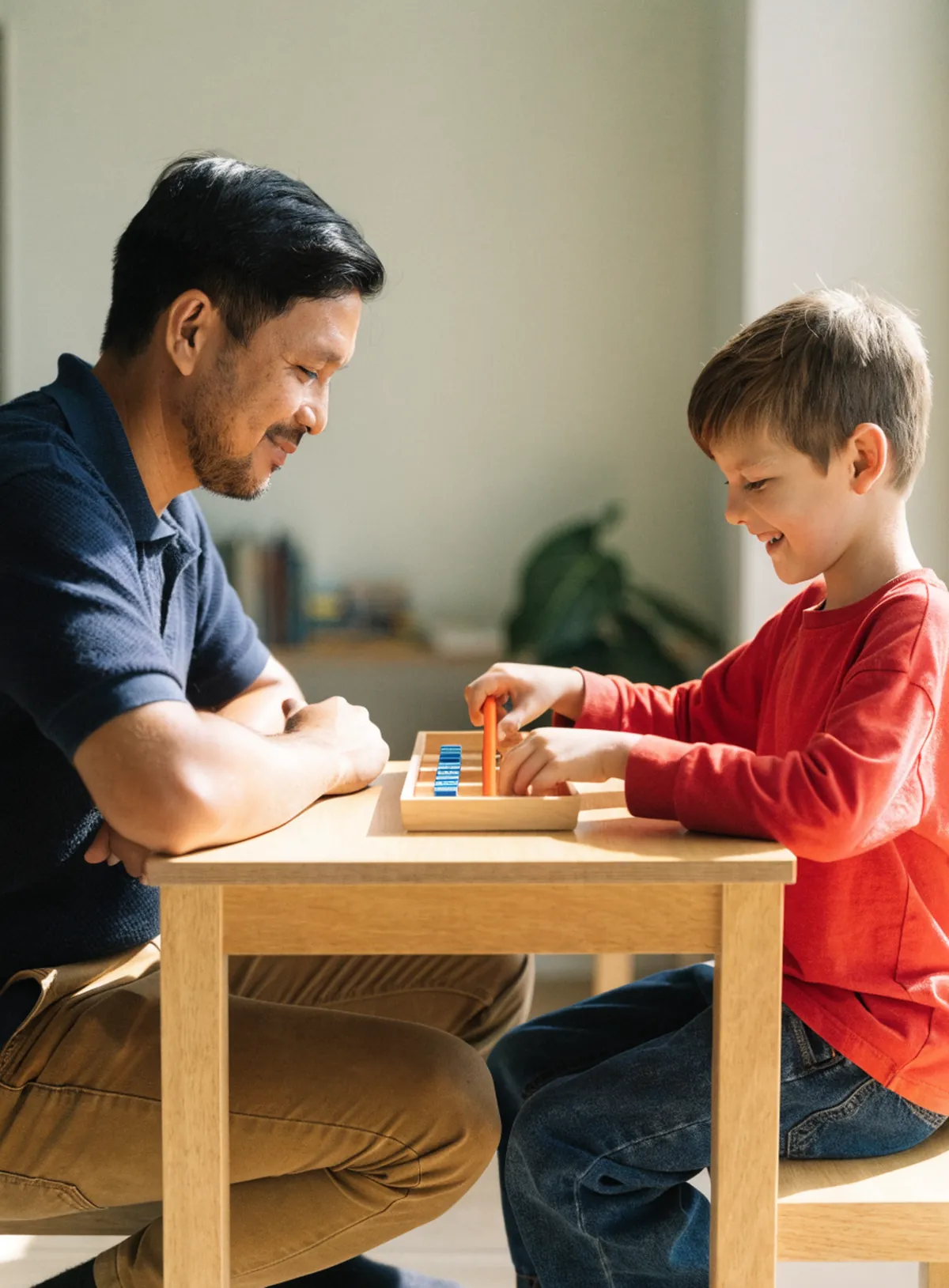 Math tutor watching a young boy count with base-ten blocks