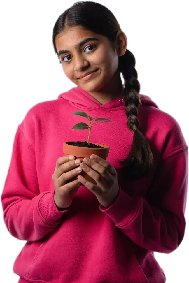 Teen biology student with a long braid, in a pink hoodie, holding a potted seedling