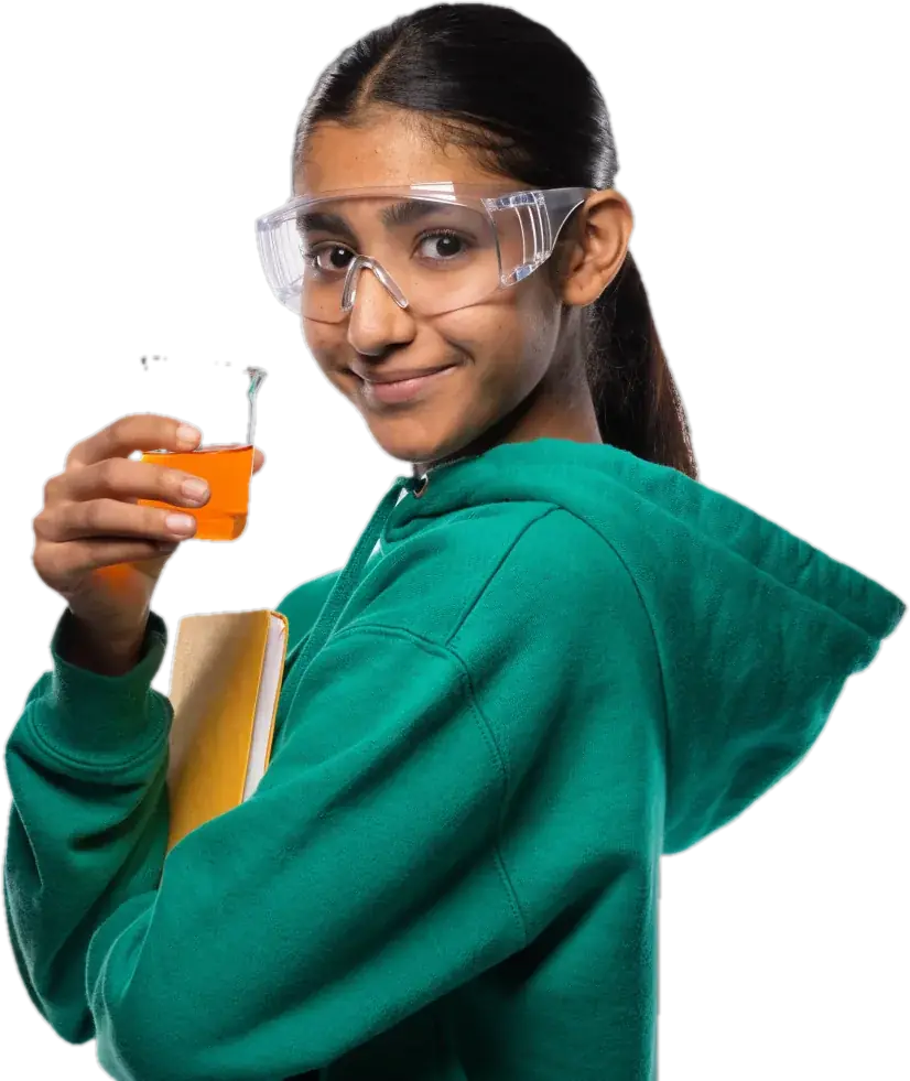 Teen chemistry student with safety goggles holding a beaker of orange liquid