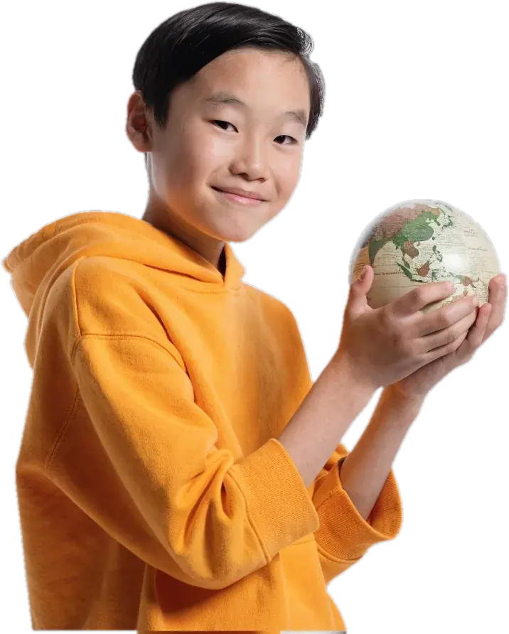Boy in a yellow hoodie holding a small globe