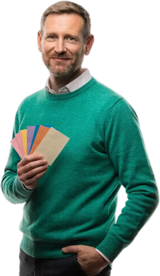 French teacher in an emerald sweater holding colourful index cards
