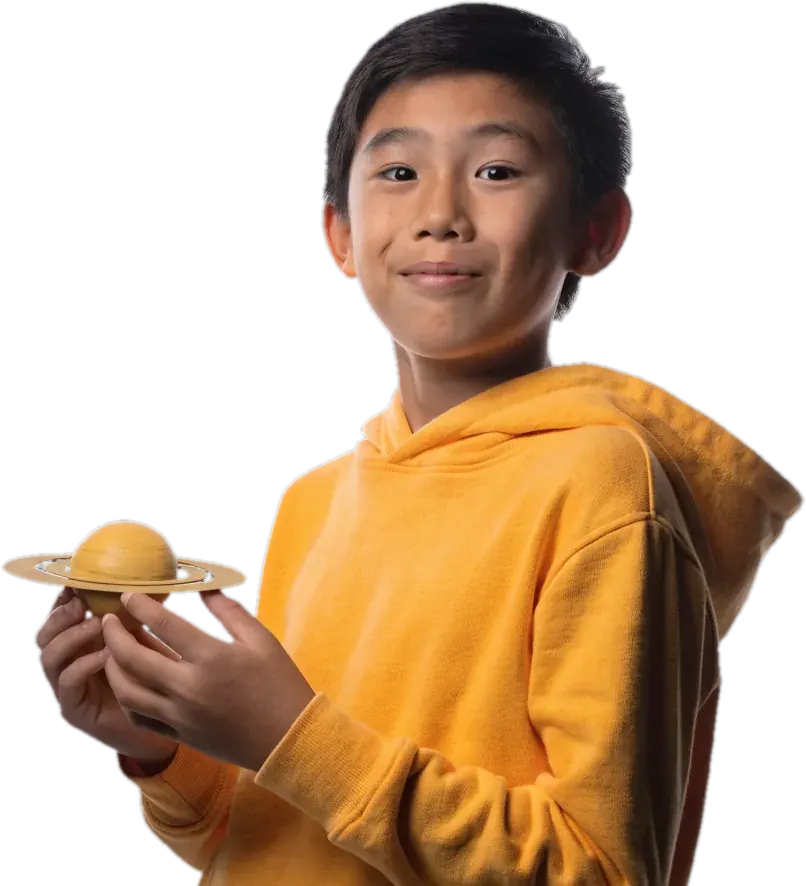 Smiling boy holding a model of the planet Saturn