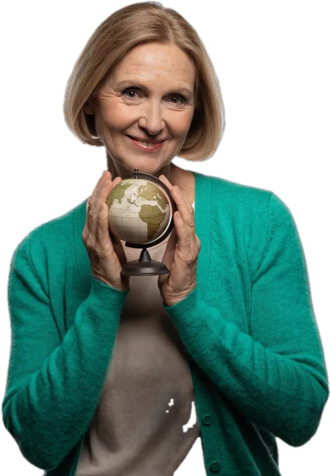 Smiling teacher in an emerald cardigan holding a small desk globe