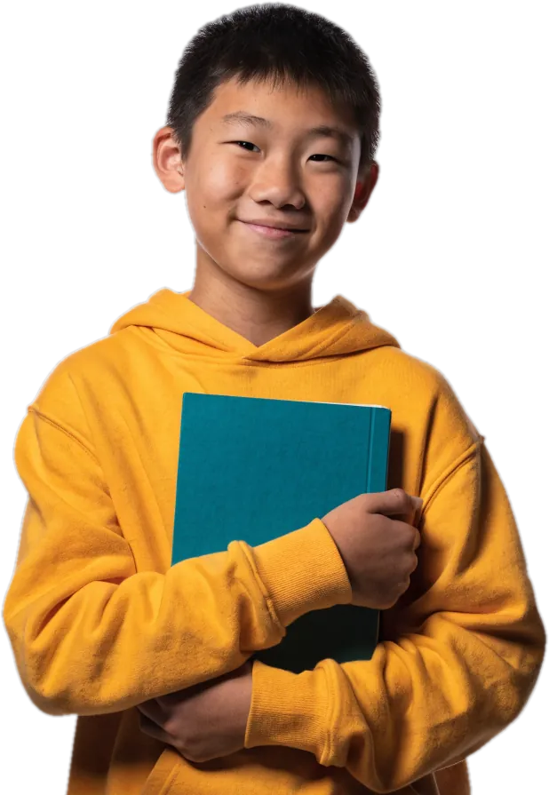 Boy in a yellow hoodie holding a teal workbook