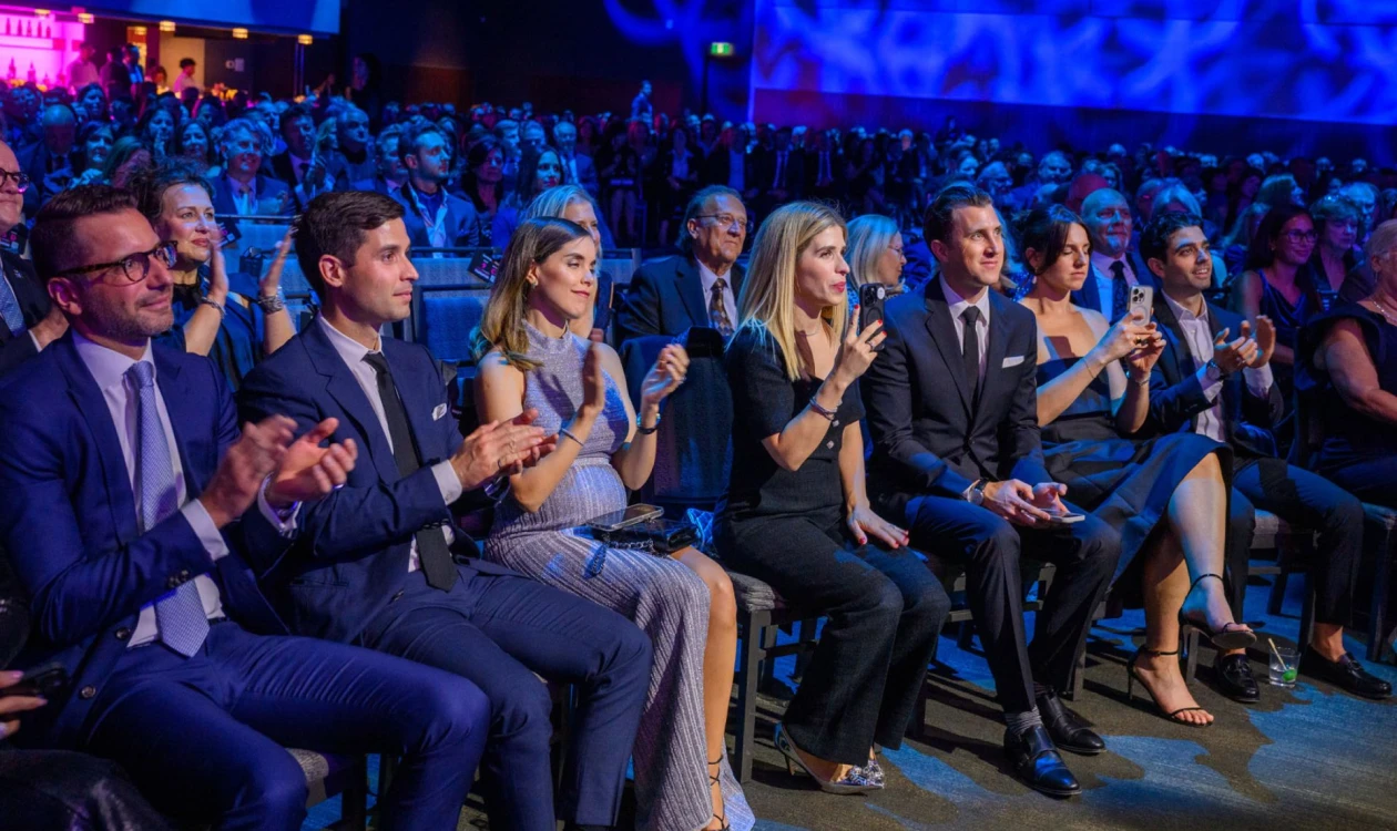 Audience in a formal event clapping their hands