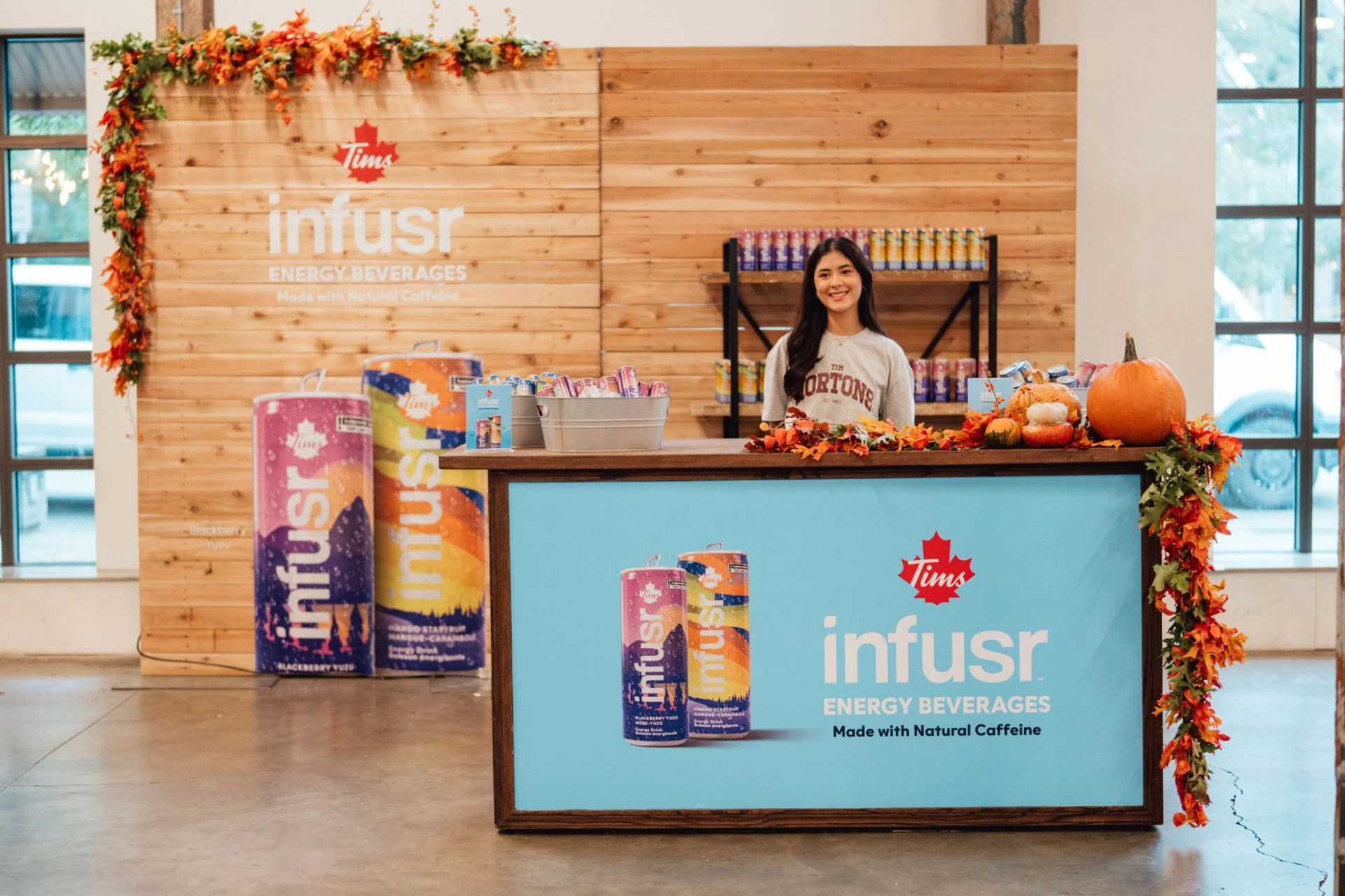 Woman standing behind a counter that gives out drinks
