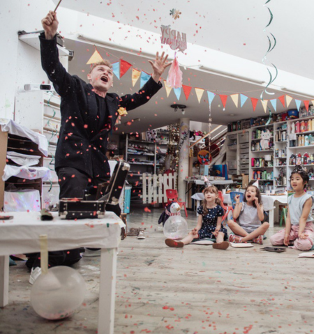 Magician in black suit with black hat