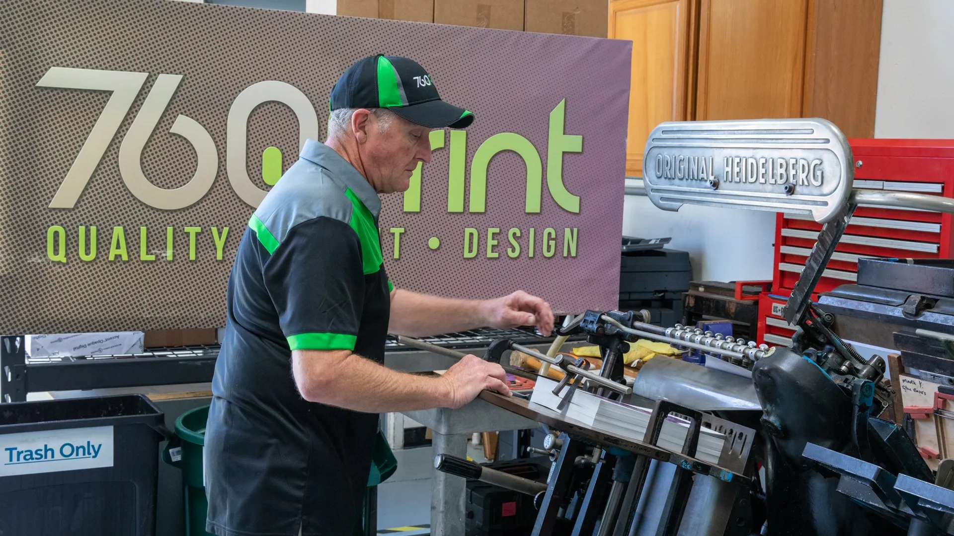 A 760 Print team member operating a Heidelberg printing press.