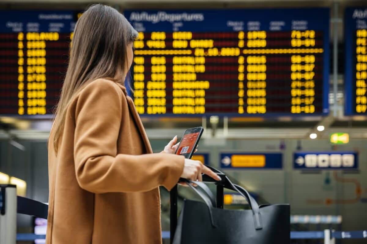 Close-up of person using mobile phone for interaction in a public environment