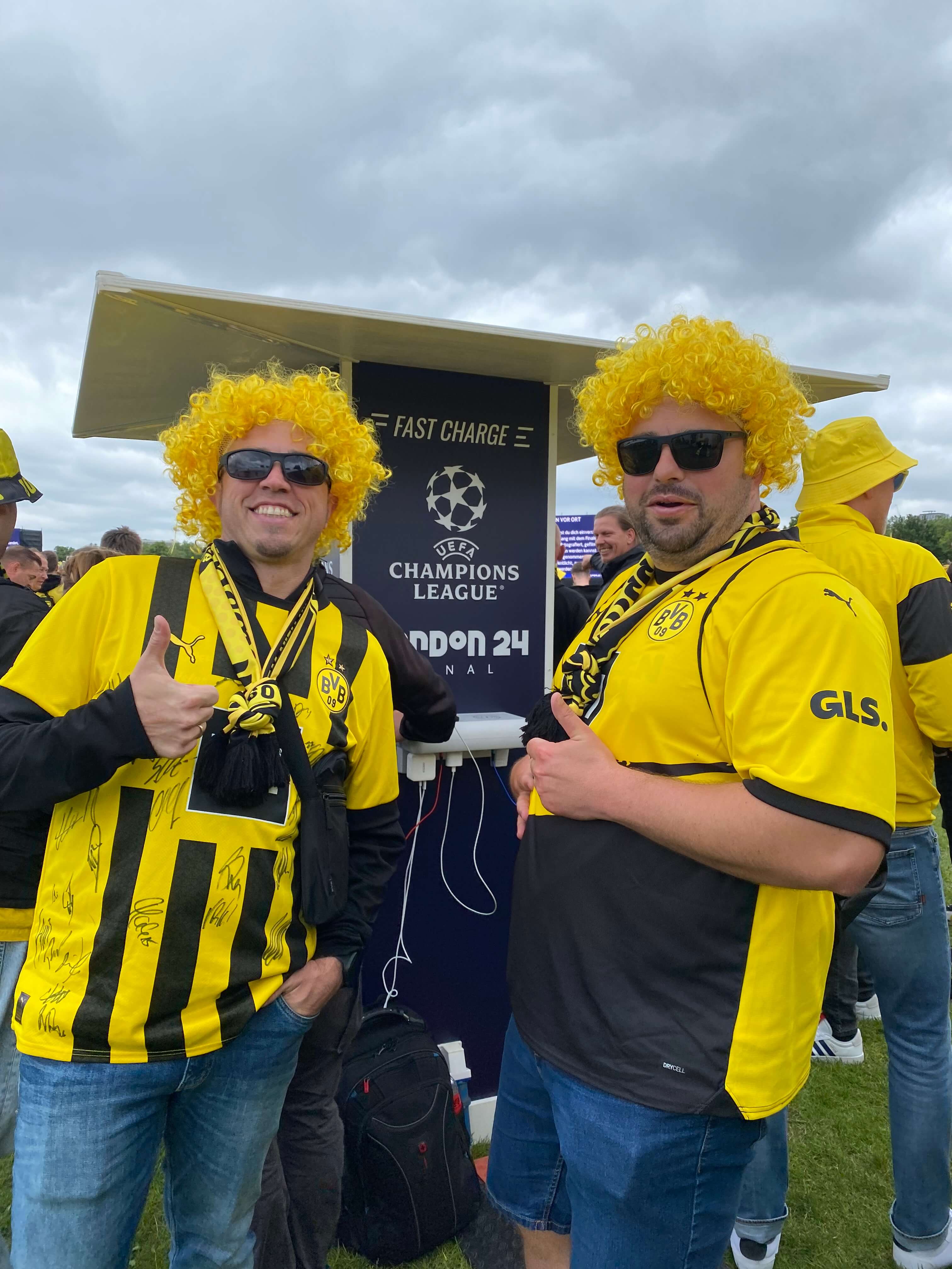 Borussia Dortmund supporters beside a phone charging station at the 2024 UEFA Champions League Final fan meeting point in London